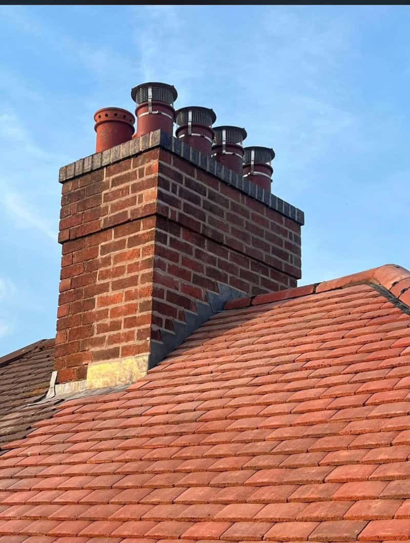 chimney-repairs-and-repointing-leicester A repointed chimney with cowls fitted over the pots