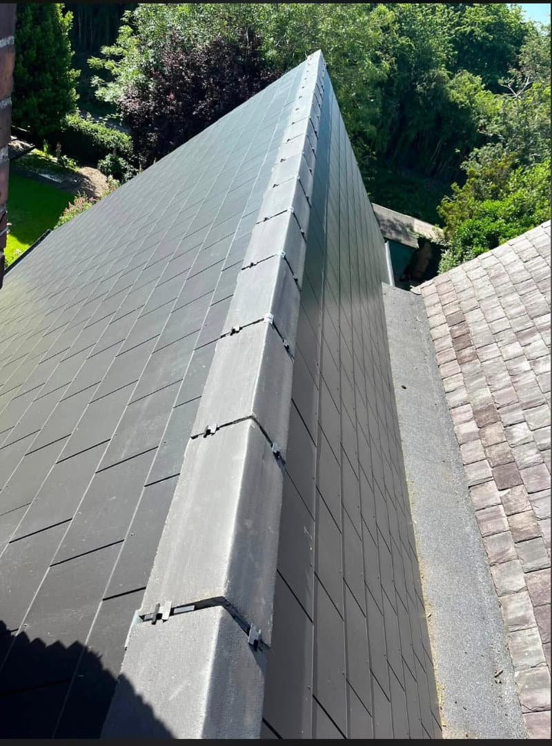 Newly fitted dry ridge tiles securing the ridge of a roof
