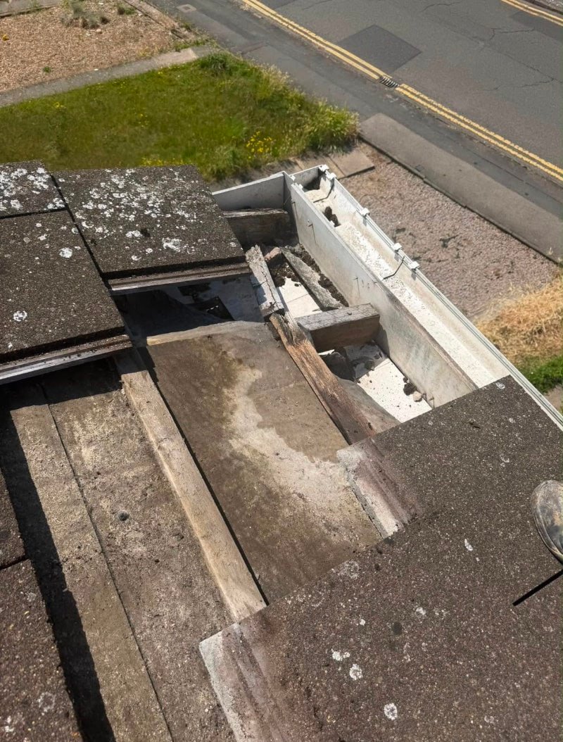 roof-repairs-leicester Close-up of a roof repair with tiles removed in one section