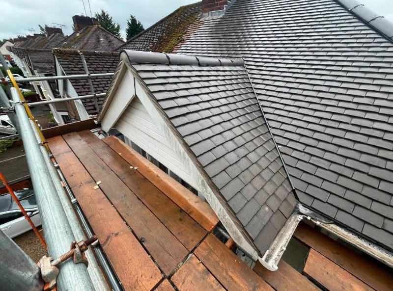 slate-and-tile-roofing-leicester Close-up of slate tiles around a gable window