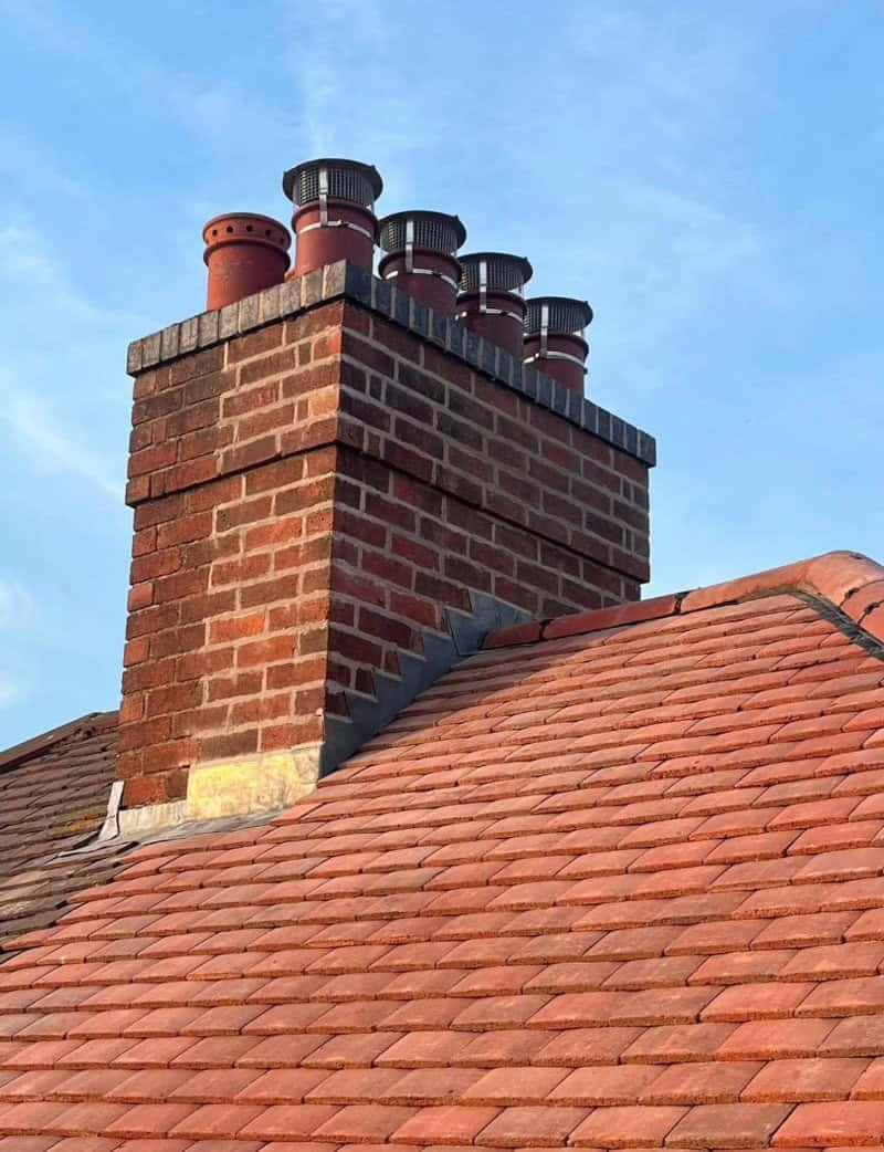 A newly repointed chimney with bird guards fitted in Melton Mowbray