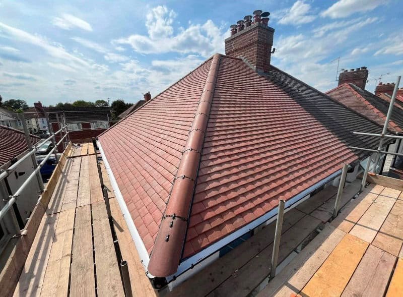 New dry ridge tiles running up a roof in Melton Mowbray